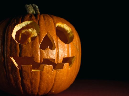 Close-up of a glowing carved pumpkin, perfect for Halloween themes.