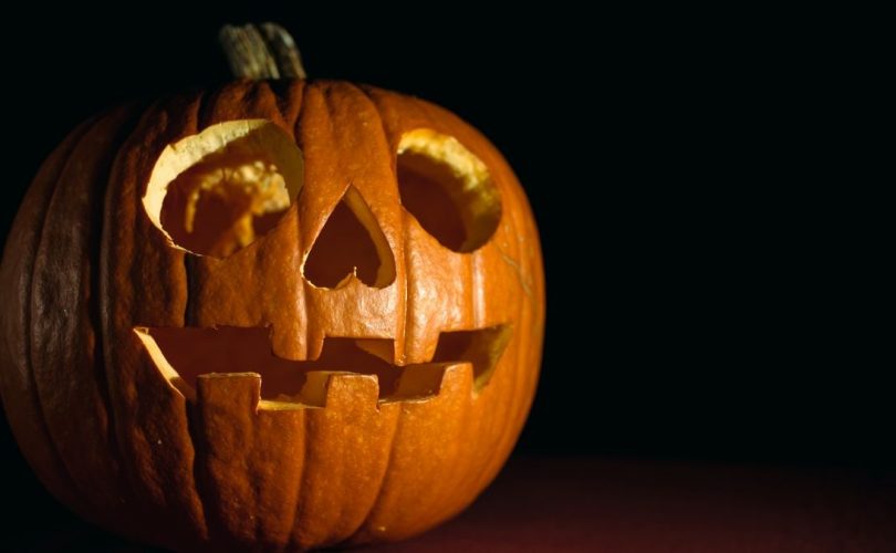 Close-up of a glowing carved pumpkin, perfect for Halloween themes.